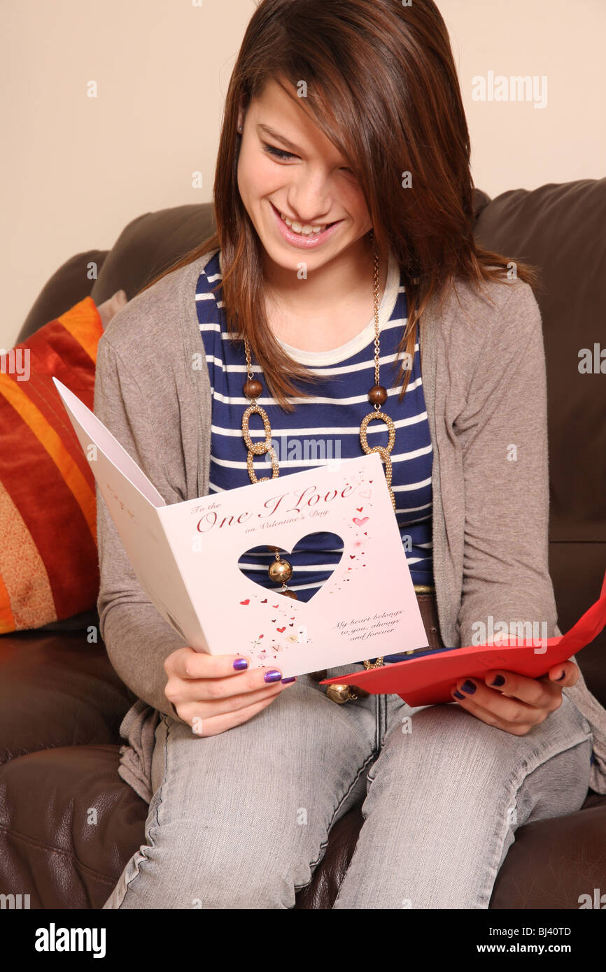 A young girl reading a Valentine card. Stock Photo