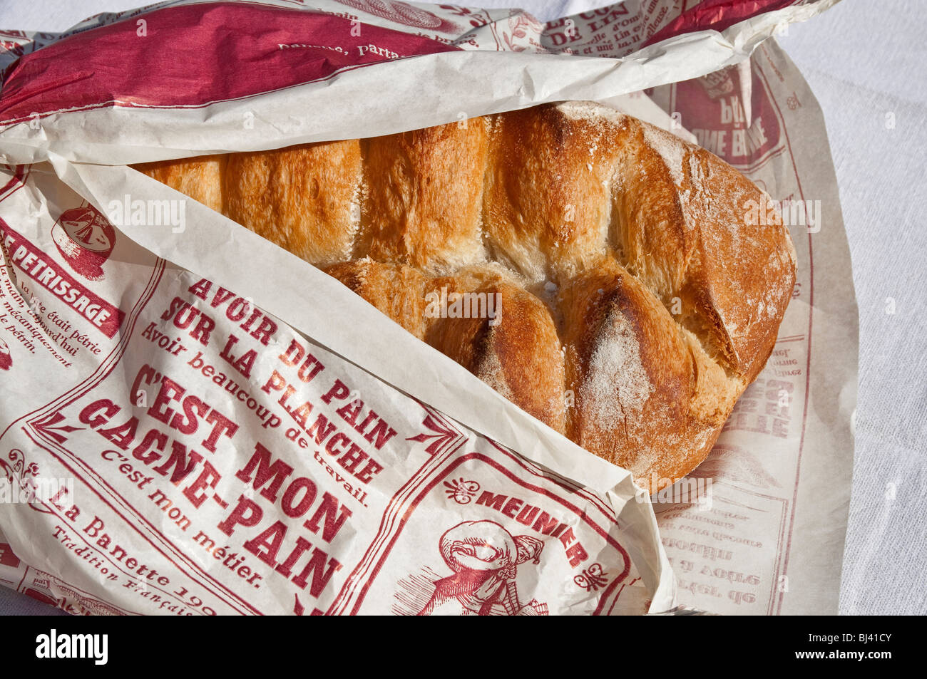 French loaf in printed paper wrapper. Stock Photo