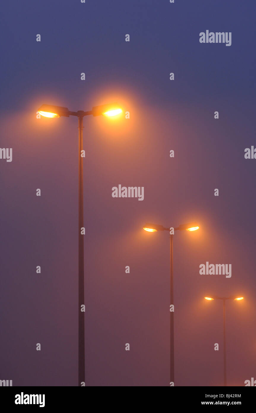 Streetlights in the fog at night Stock Photo