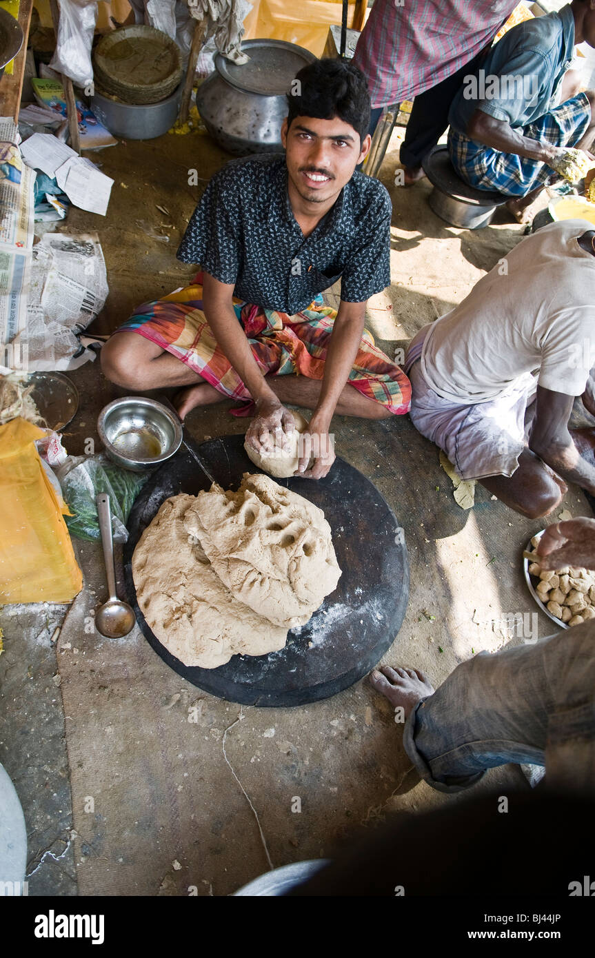 Making fresh Chapatis on his Tawa. Stock Photo