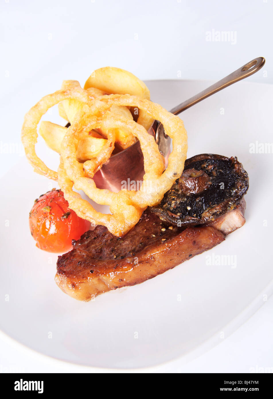 Fried Sirloin Steak with Chips and Tempura Batter Onion Rings Stock Photo