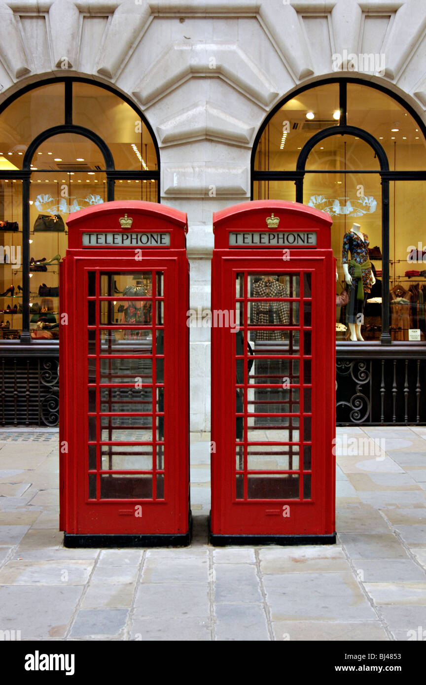 Two telephone kiosks in front of upmarket shops, London Stock Photo