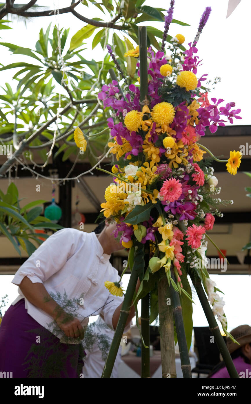Thai woman arranging bouquet of flowers Stock Photo