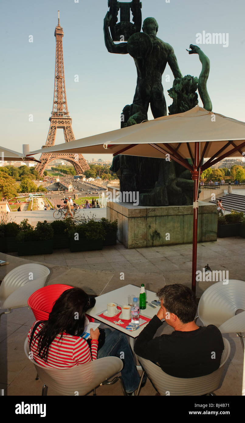 Paris Cafe, France, Couple in French Cafe Bistro Restaurant, Sidewalk terrace in Trocadero, With Eiffel Tower, Behind, coffee shop, terrasse, Paris Romance Stock Photo