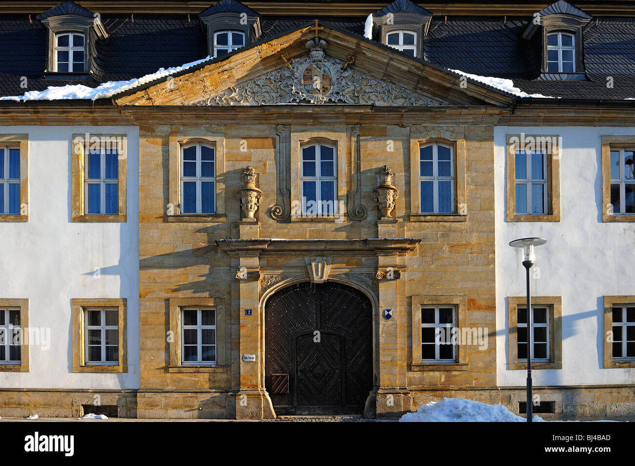 Baroque facade, Catholic parish office, on top old coat of arms of the Prince Bishop, Balthasar-Neumann-Strasse 2, Goessweinste Stock Photo