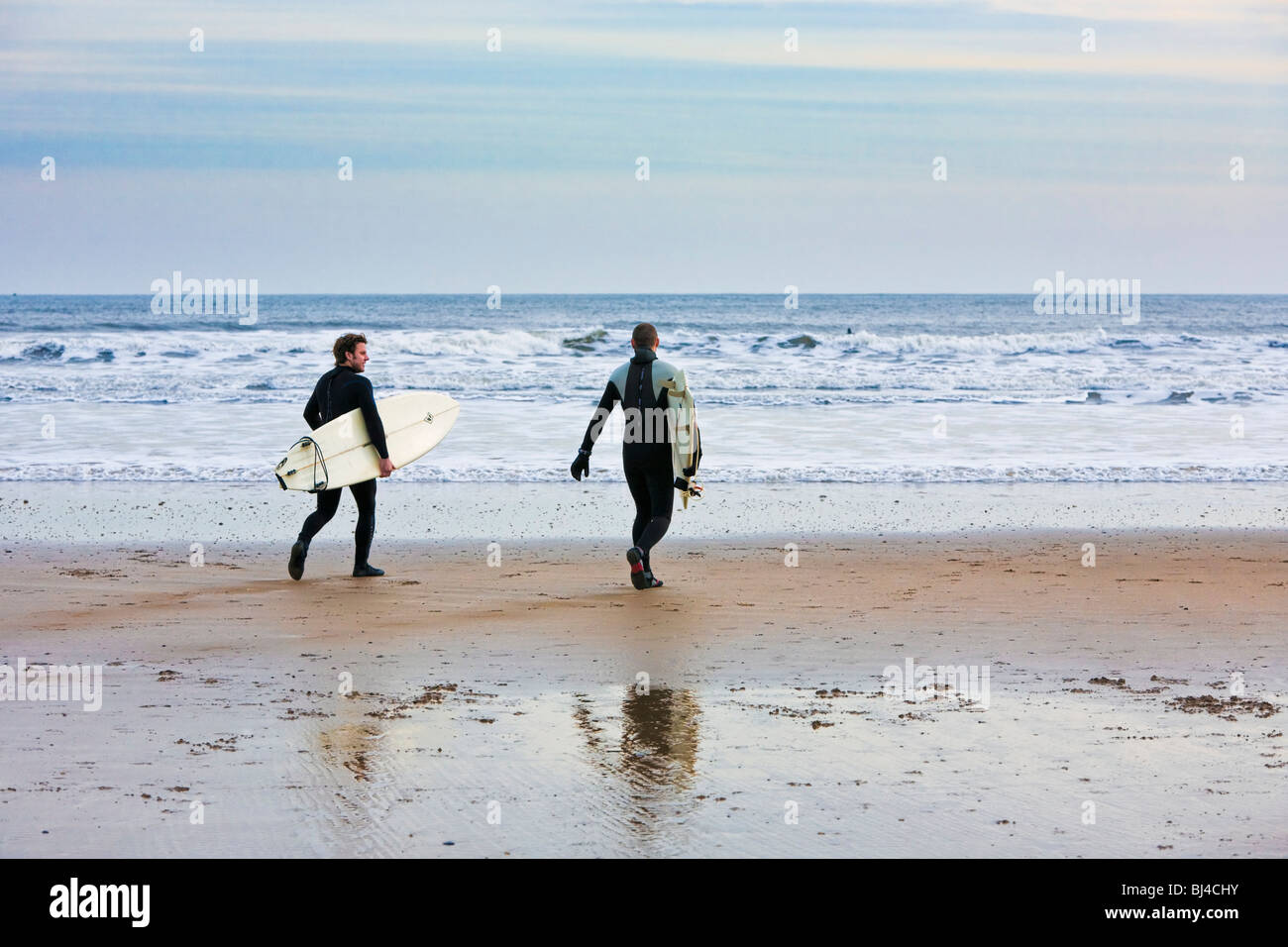 Surfers on a beach UK Stock Photo