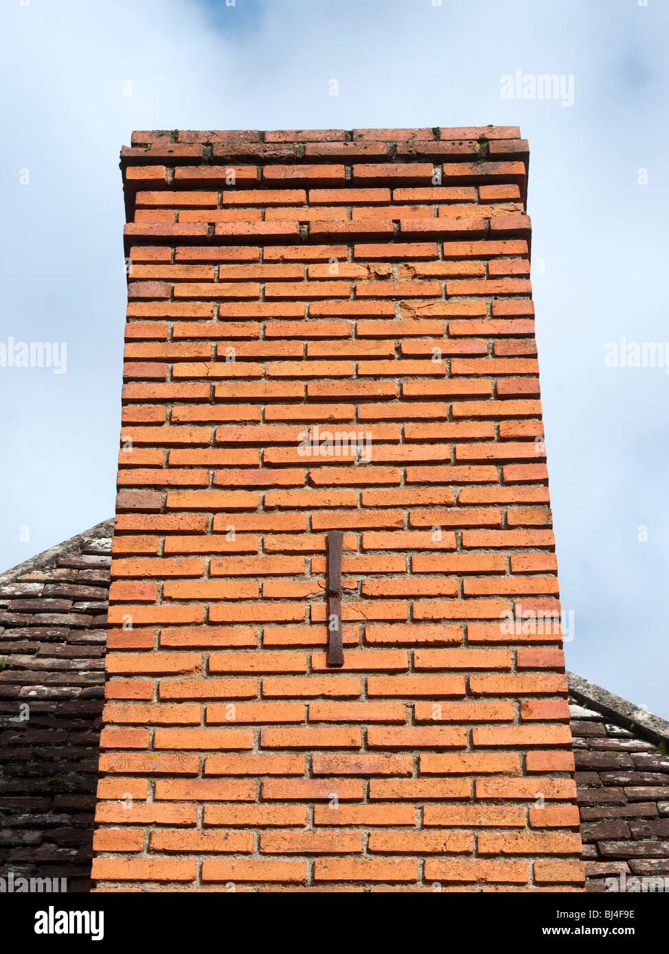 Decorative letter 'I' reinforcing chimney stack - France. Stock Photo