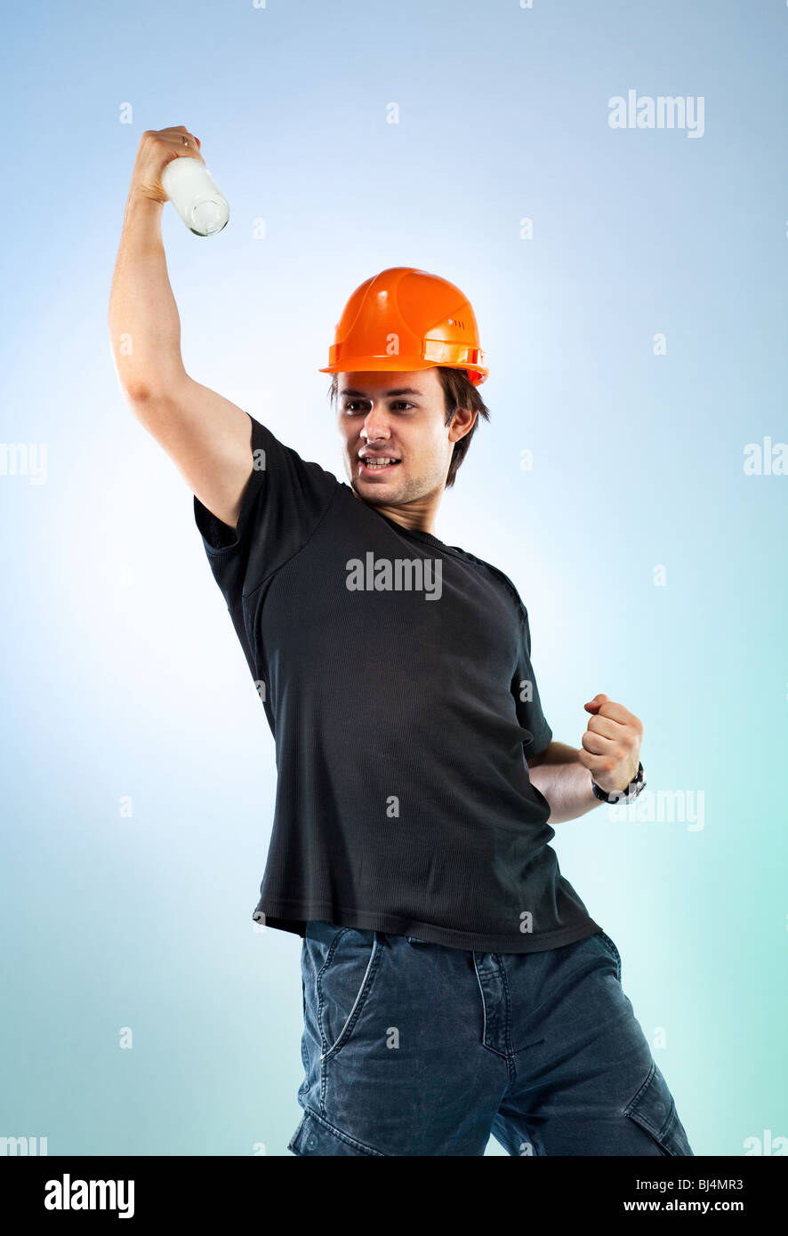 Workman with bottle. On bright colour background. Stock Photo