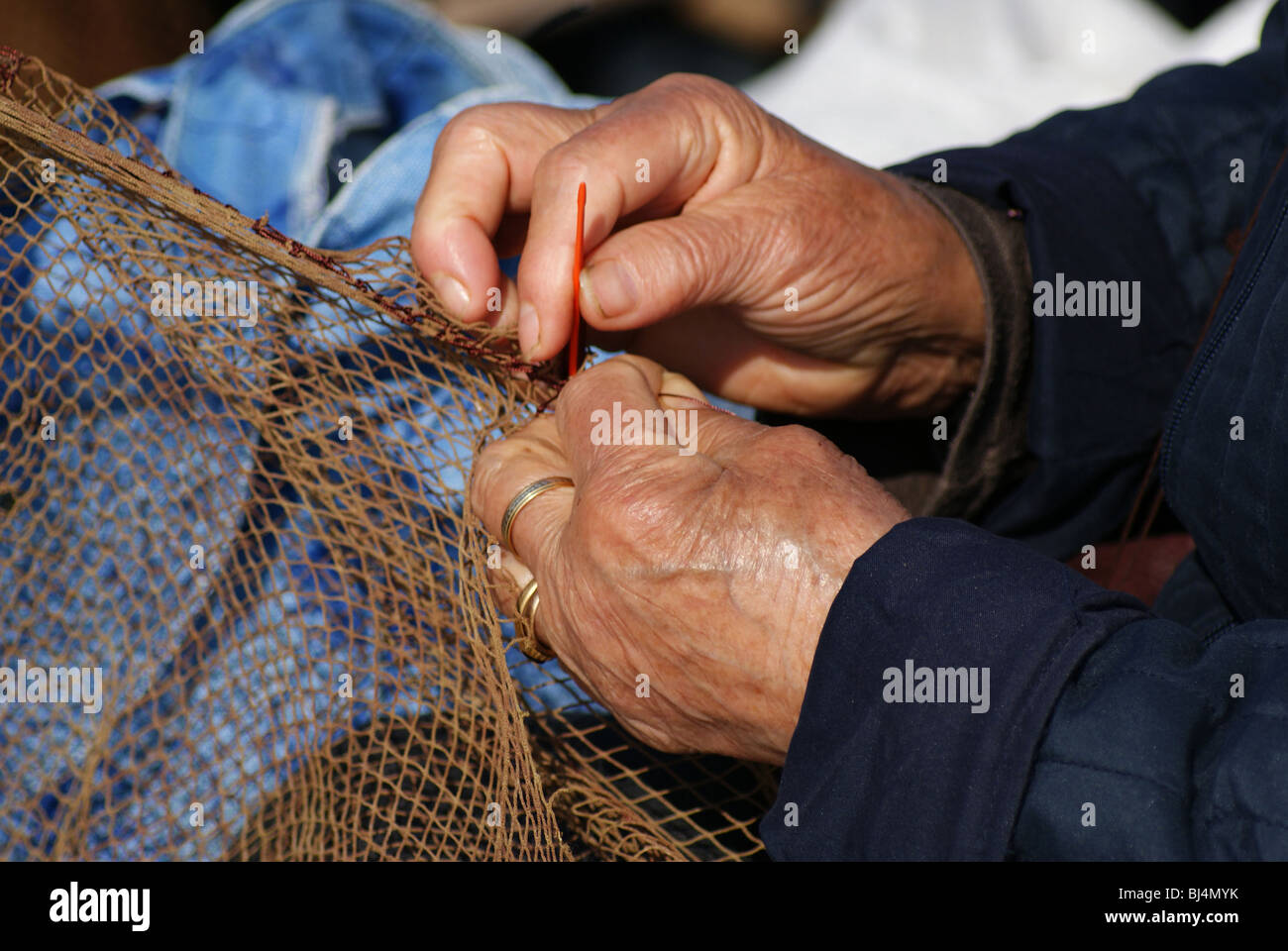 Women sewing fishing nets Stock Photo - Alamy