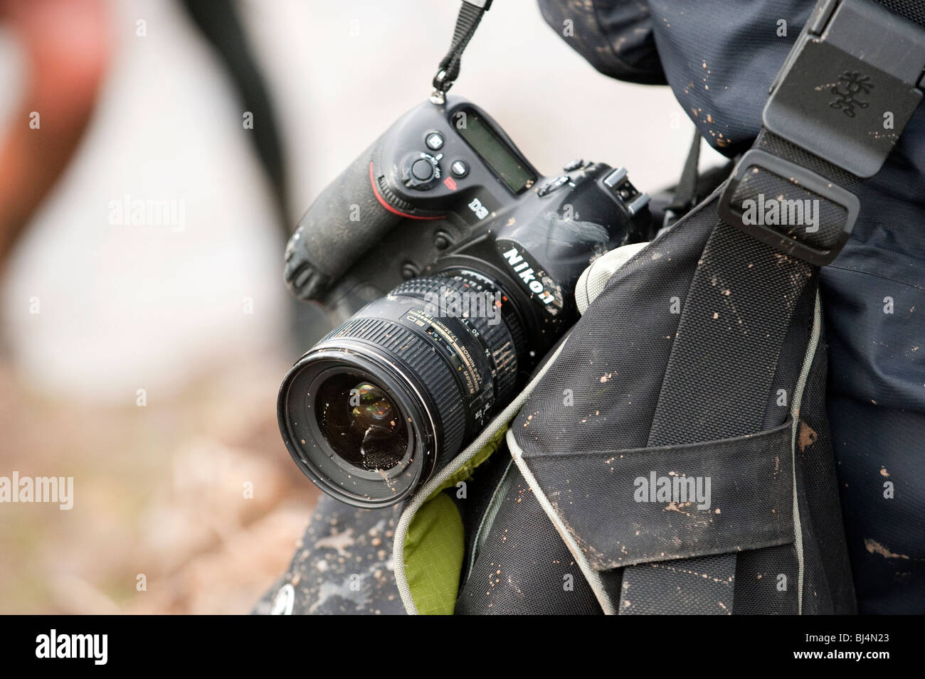 photographer with mud all over multiple cameras at sporting event Stock Photo