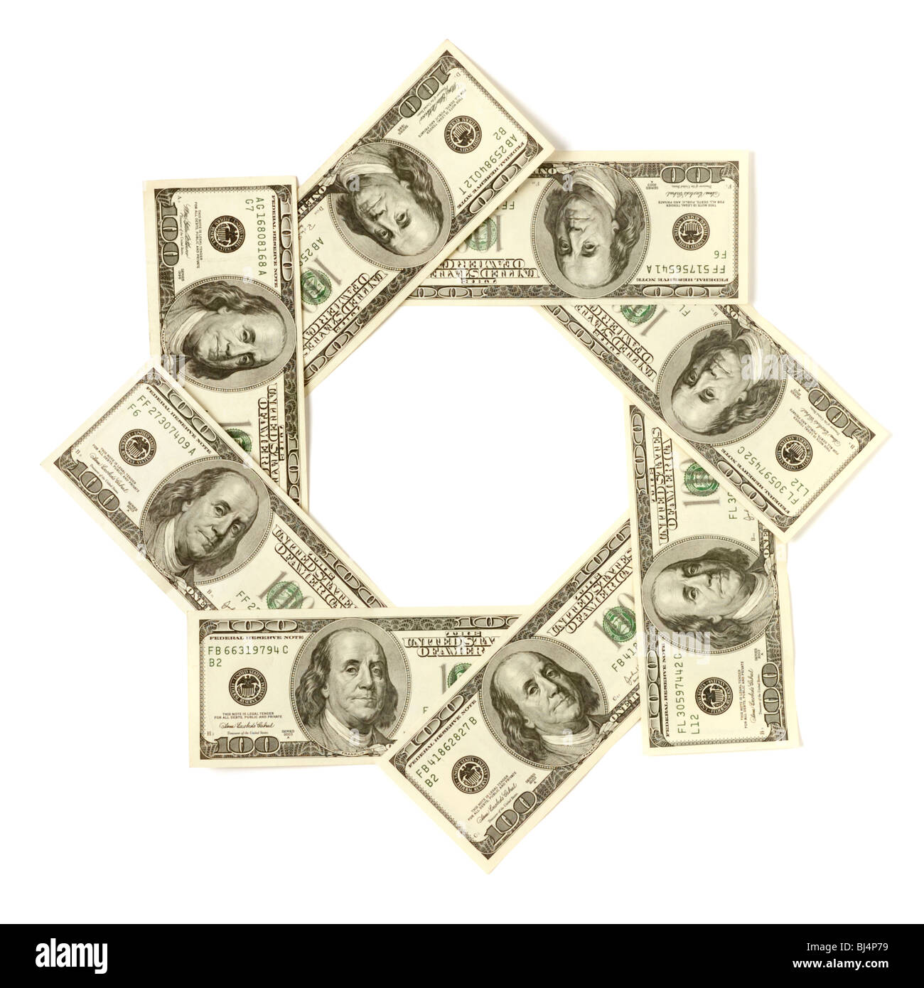 Artistic pattern made from dollar bills Snowflake star or aperture Isolated with a clipping path on white background Stock Photo