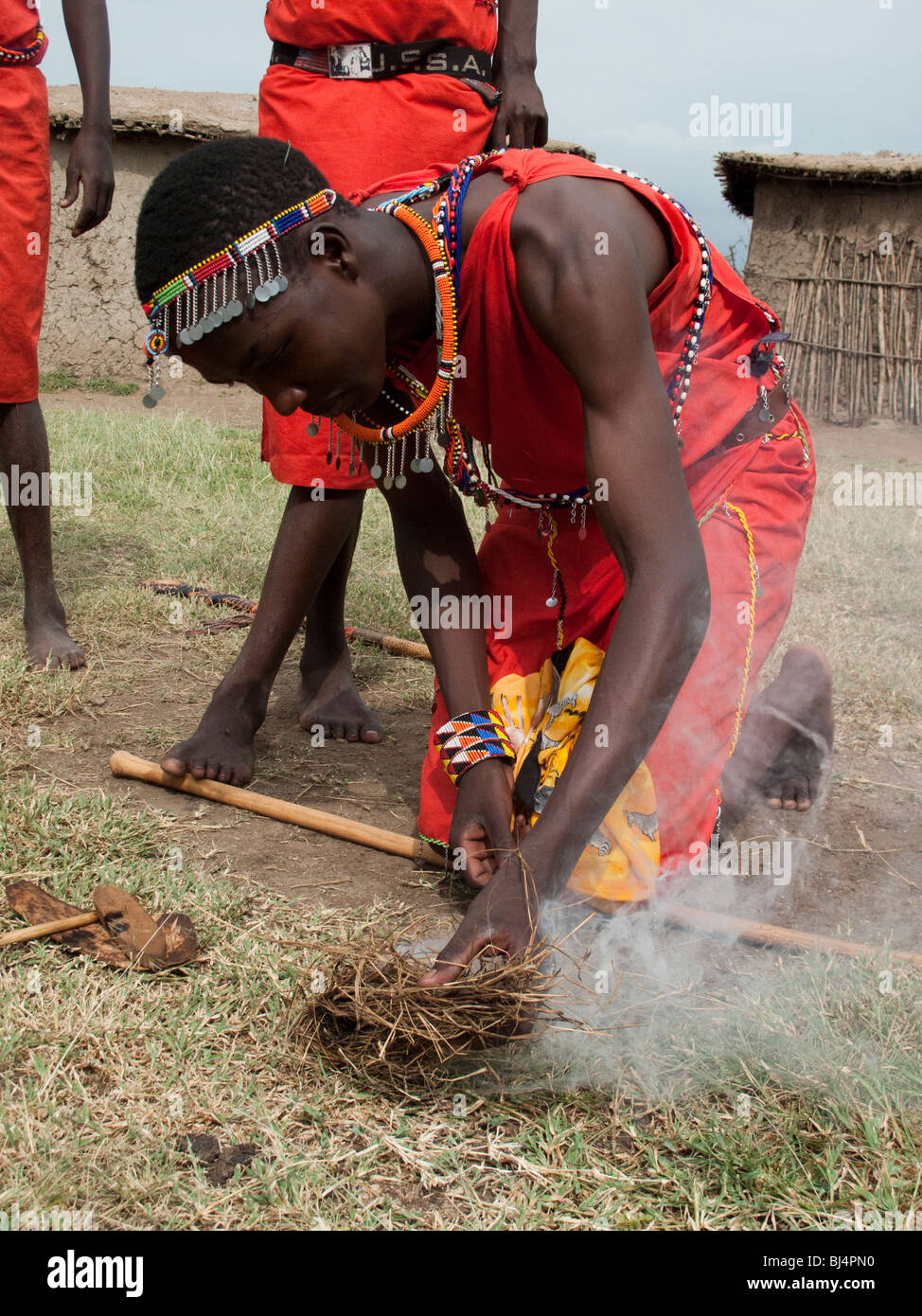 Young man making fire in a Masai village, Kenya, East Africa Stock