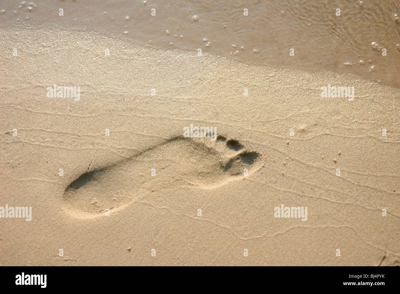 Human footprint on sand Stock Photo