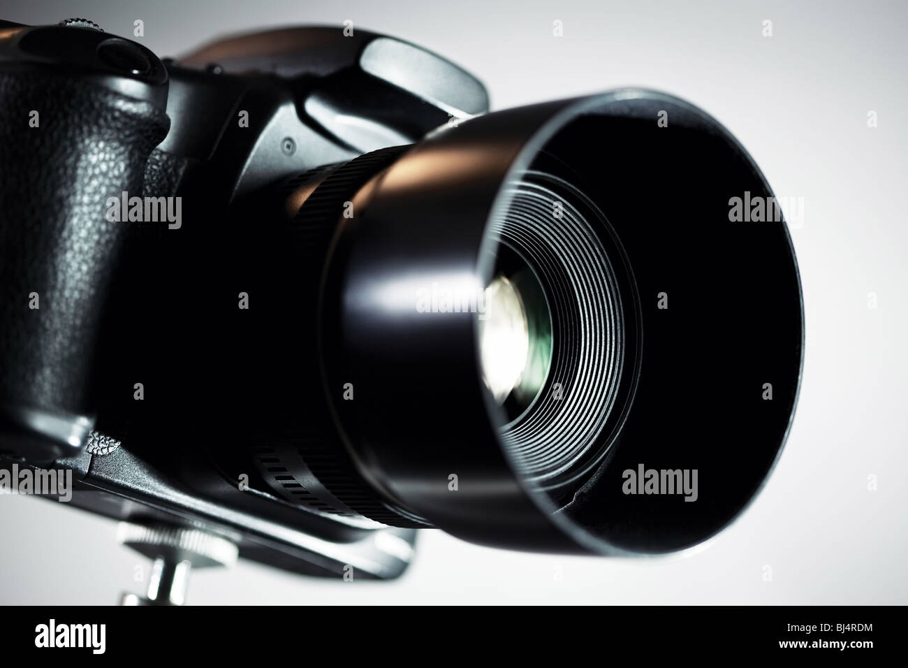 Professional DSLR camera on grey background. Stock Photo