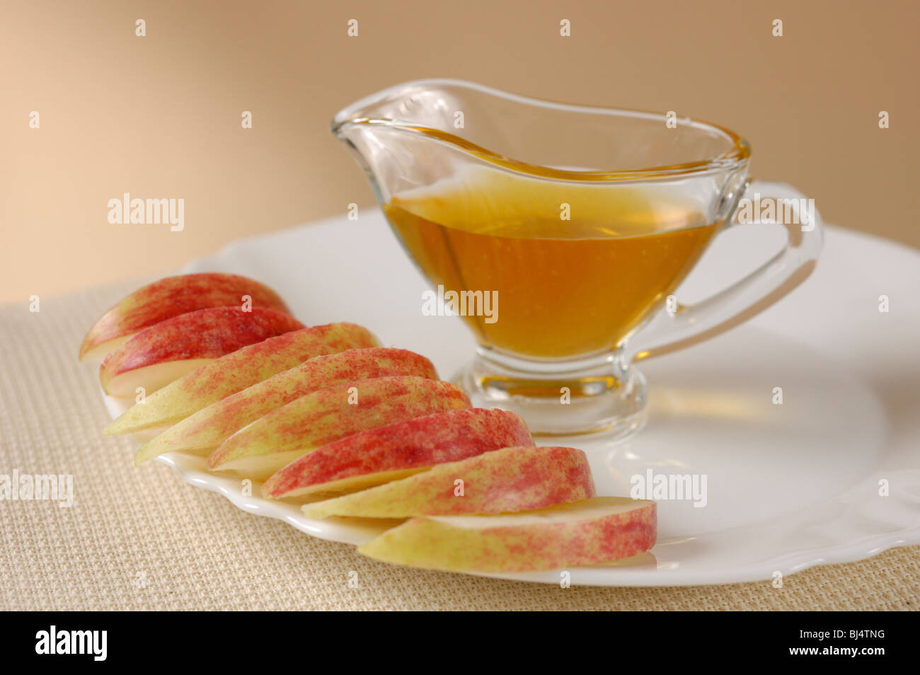 Slices of apple on plate and honey still life Stock Photo
