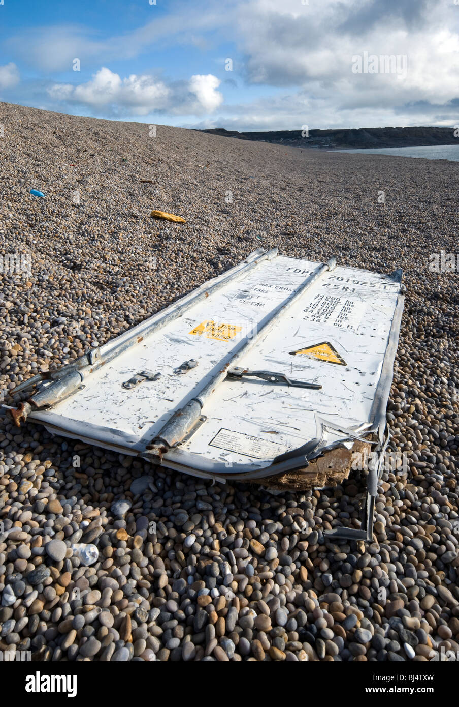 container door washed up on chesil beach dorset Stock Photo