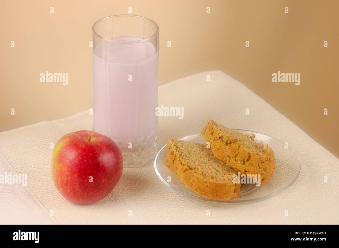 Home made bread, glass of yogurt and an apple Stock Photo