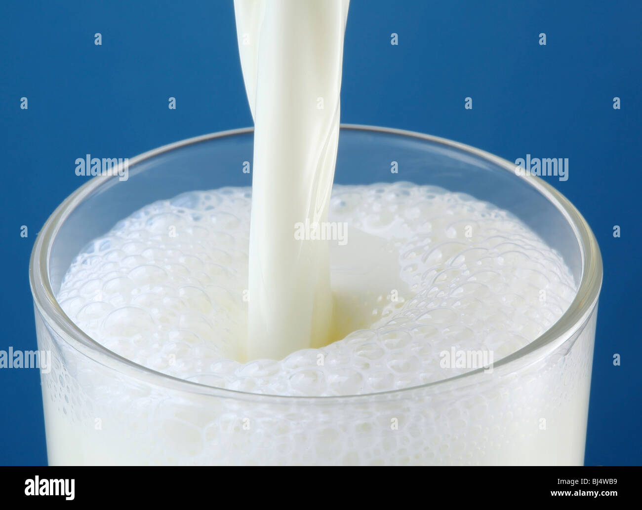 Glass of milk on a blue background Stock Photo