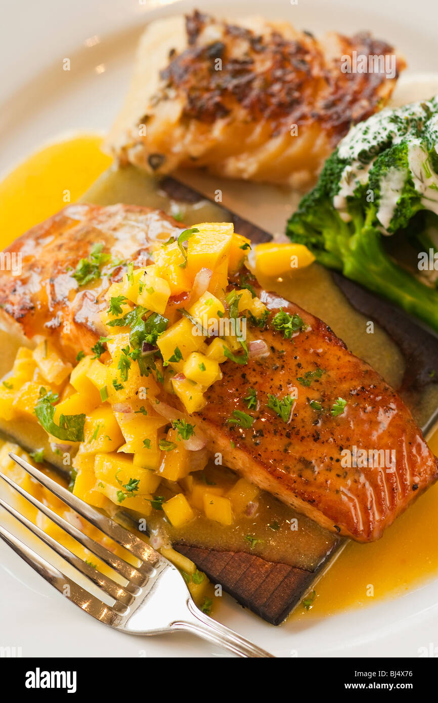 cedar plank cooked salmon with mango salsa, broccoli and potato
