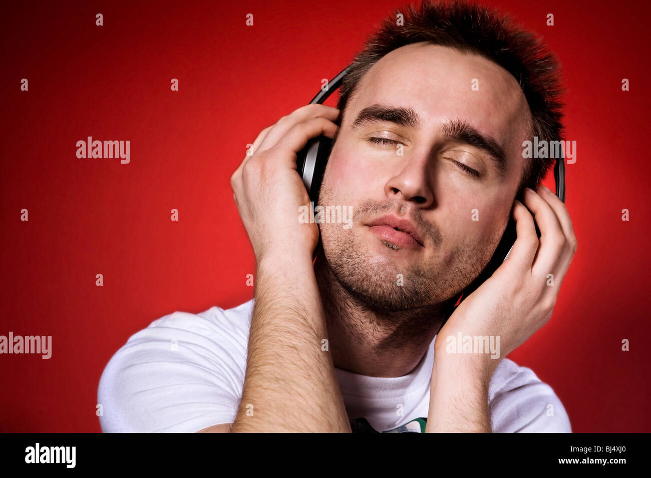 young man listening to the music with eyes closed Stock Photo