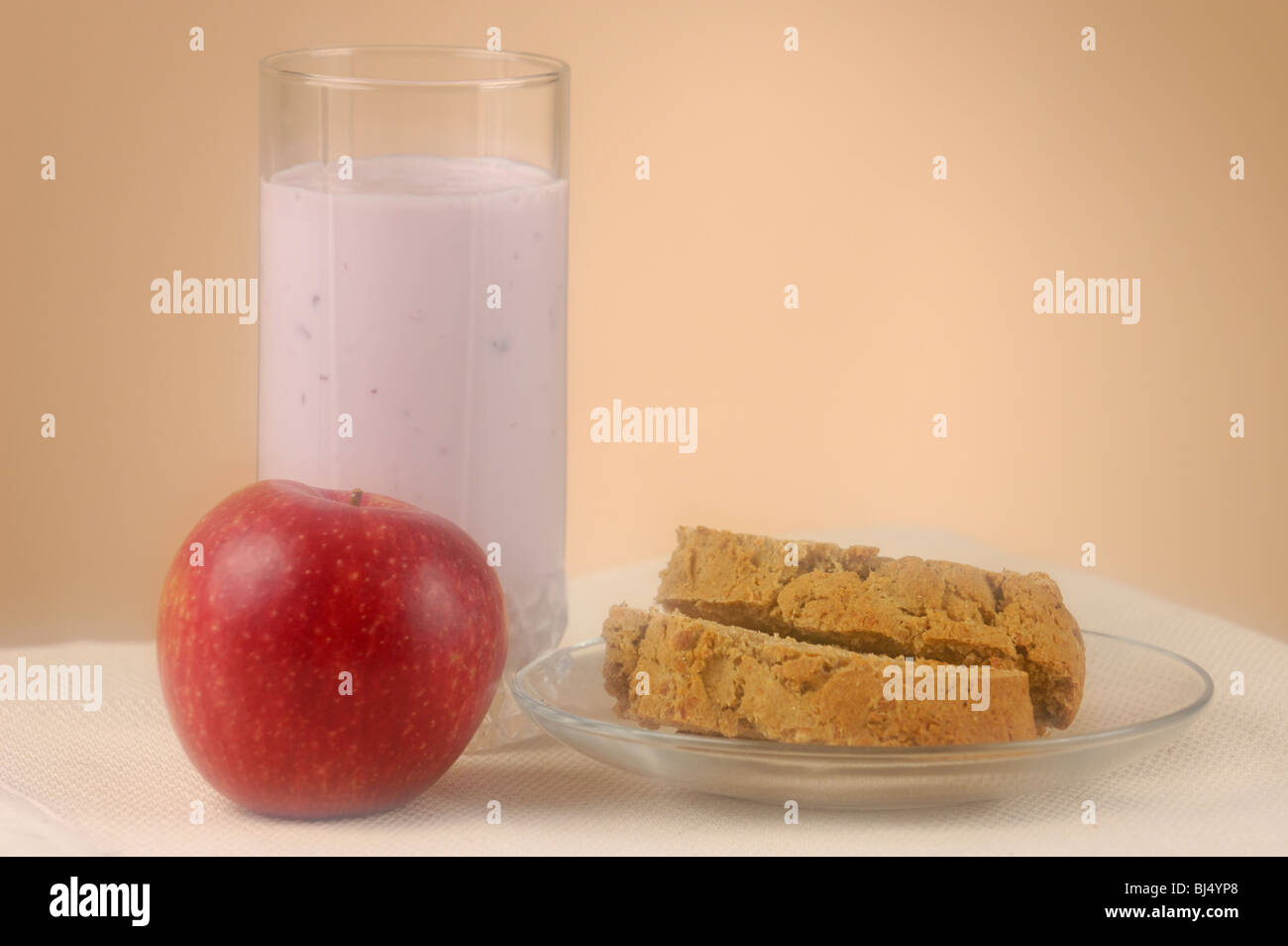 Home made bread, glass of yogurt and an apple Stock Photo