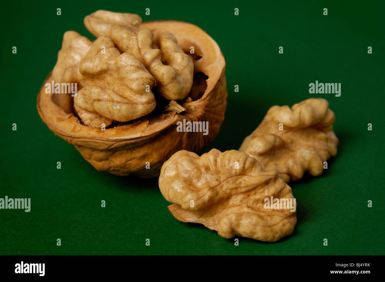 Walnut closeup isolated on green background artistic food still life ...