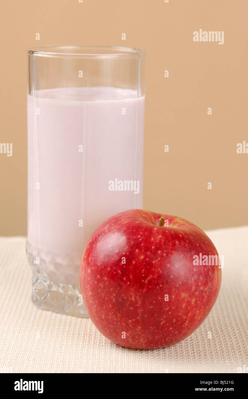 Glass of yogurt and an apple Stock Photo