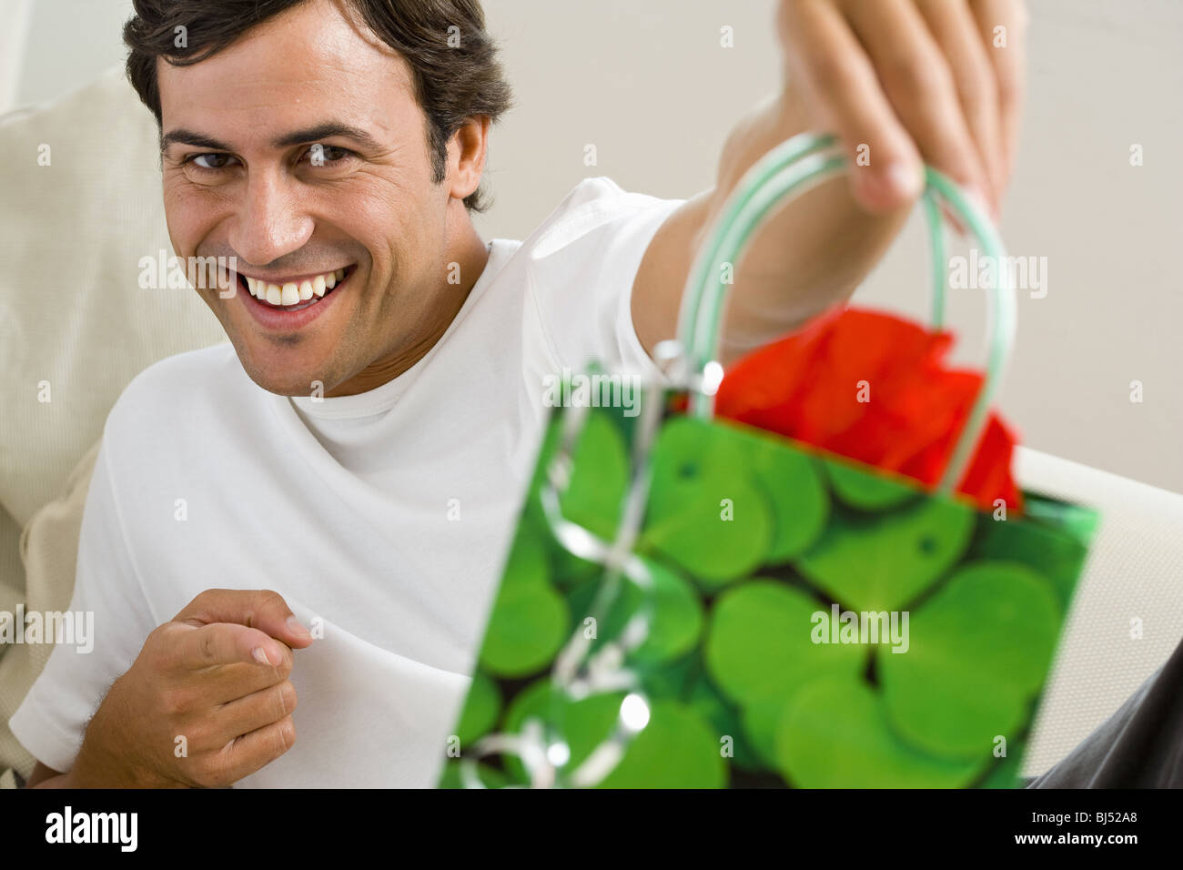 Man holding gift bag Stock Photo Alamy
