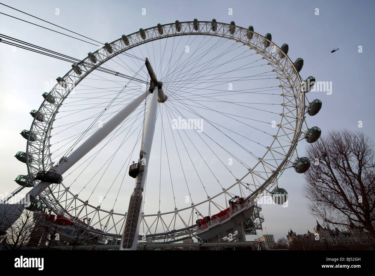 London Eye Southbank London England UK with helicopter flying by Stock Photo