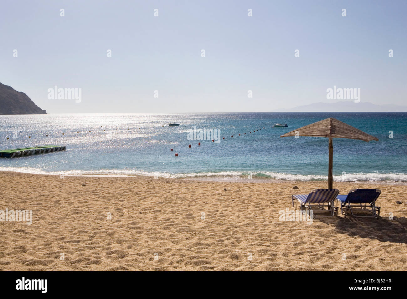 Two sunbeds on sandy beach Stock Photo Alamy