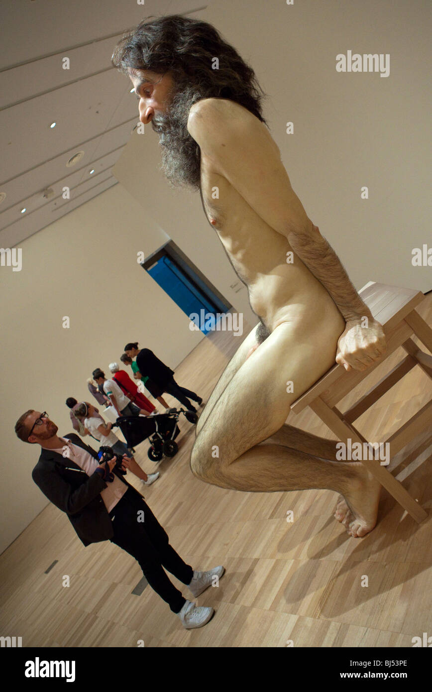 Man viewing a Ron Mueck sculptiure at the National Gallery of Victoria, Melbourne Stock Photo