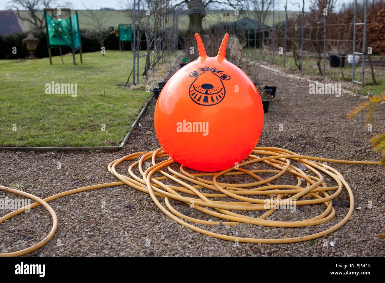 An orange spacehopper in the garden Stock Photo