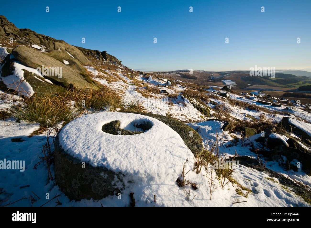 Abandoned millstone below Stanage Edge, Peak District, Derbyshire, UK Stock Photo