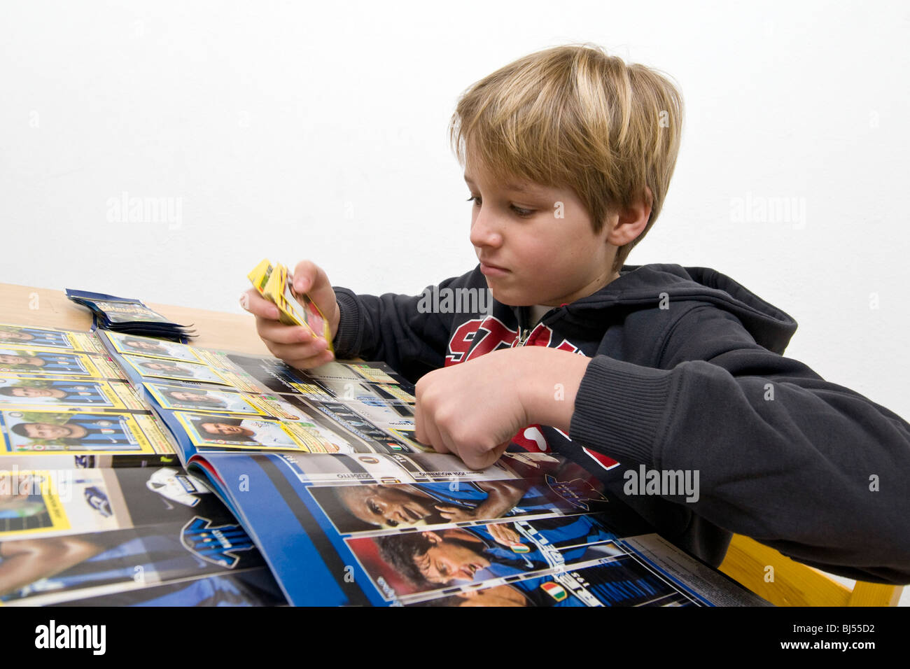 child with football collection cards Stock Photo