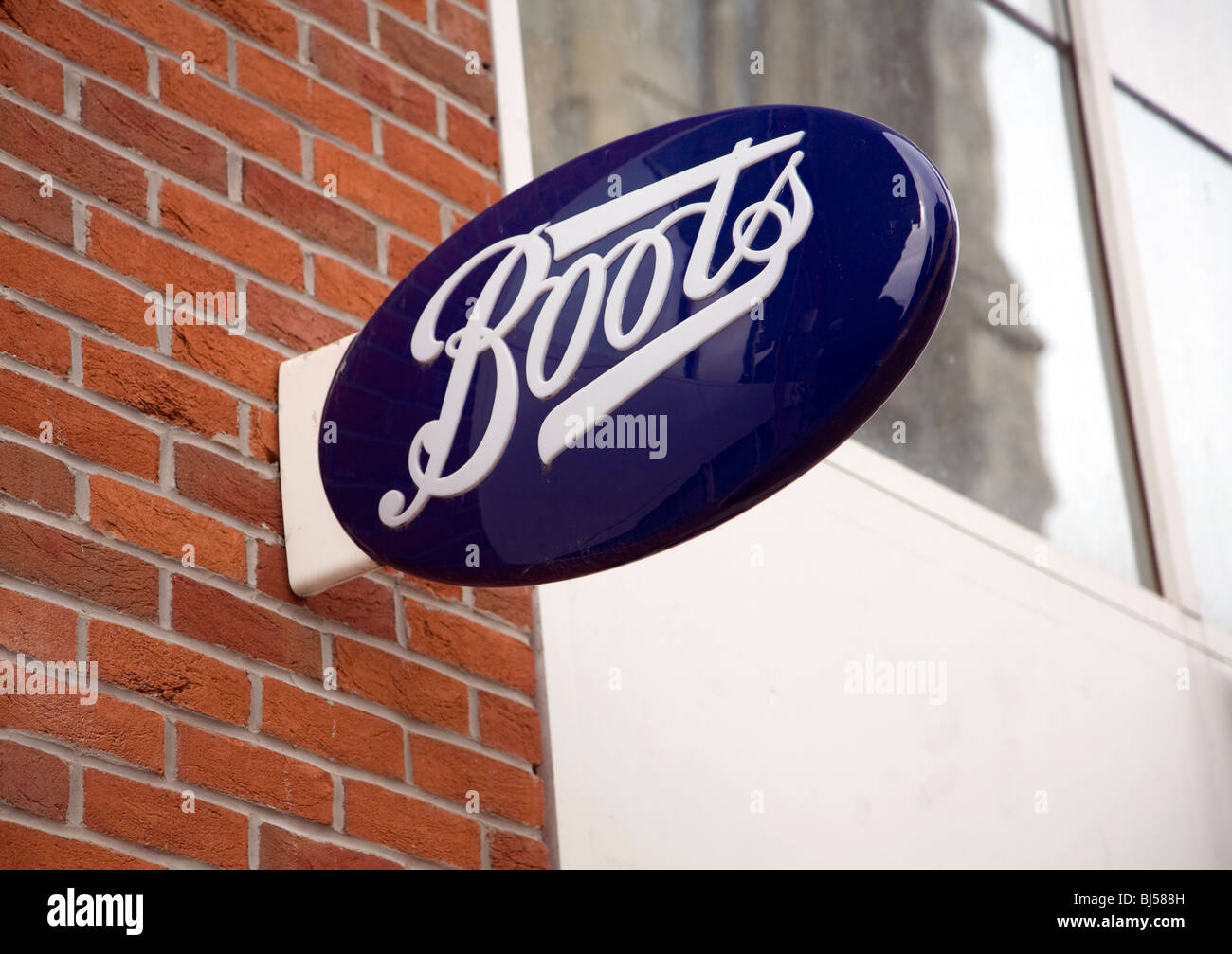 Boots shop sign on wall Stock Photo - Alamy