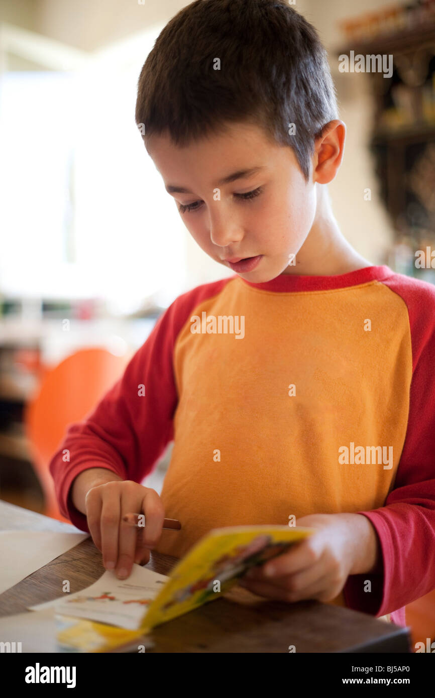 little boy reading, drawing in book Stock Photo - Alamy