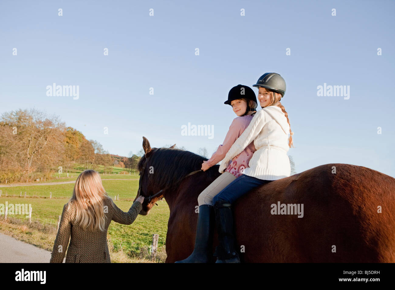 Two girls on a horseback Stock Photo - Alamy