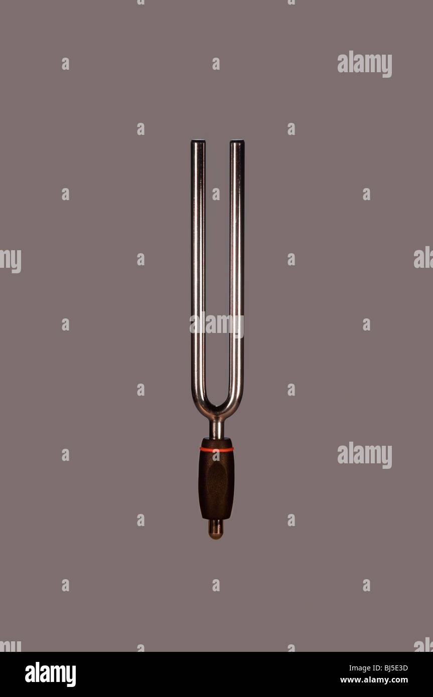 Cut Out. Tuning Fork with Black Handle on Gray Background. Stock Photo