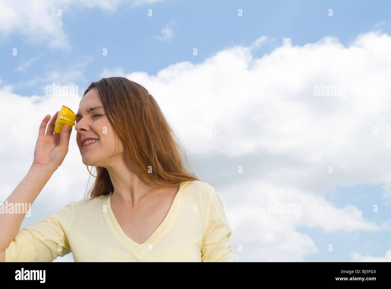 woman, field, sky, playful, exotic fruit, star fruit, eyes, escape, kaleidoscope, fun Stock Photo