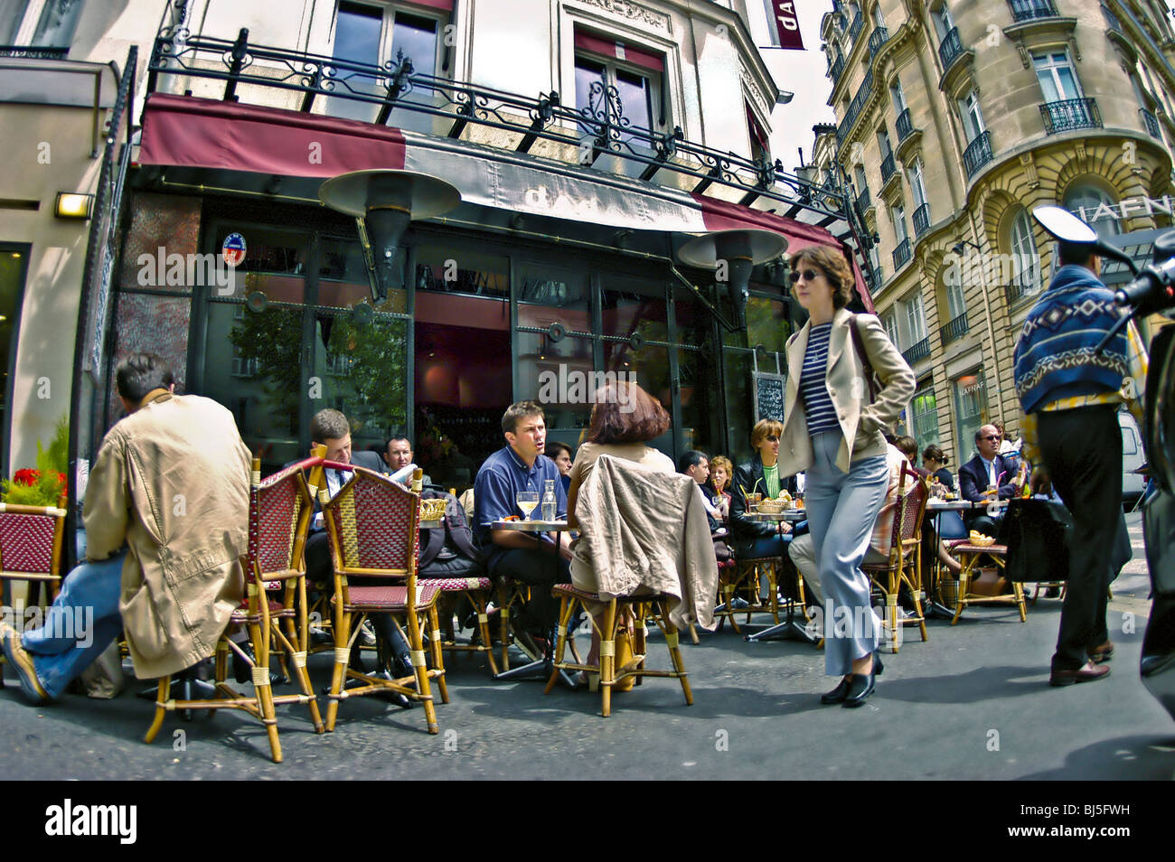 PARIS, France - Crowd of people Sharing Meals at Trendy French Café Bistro Restaurant 'Le Dada', Outside Sidewalk Terrace, group drinking coffee bar, sidewalk, woman Stock Photo