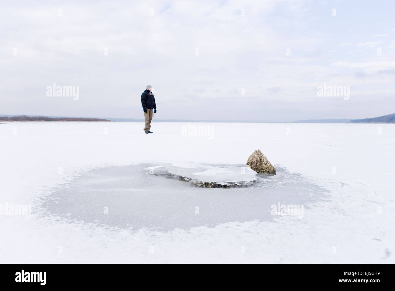 Man on frozen lake Stock Photo