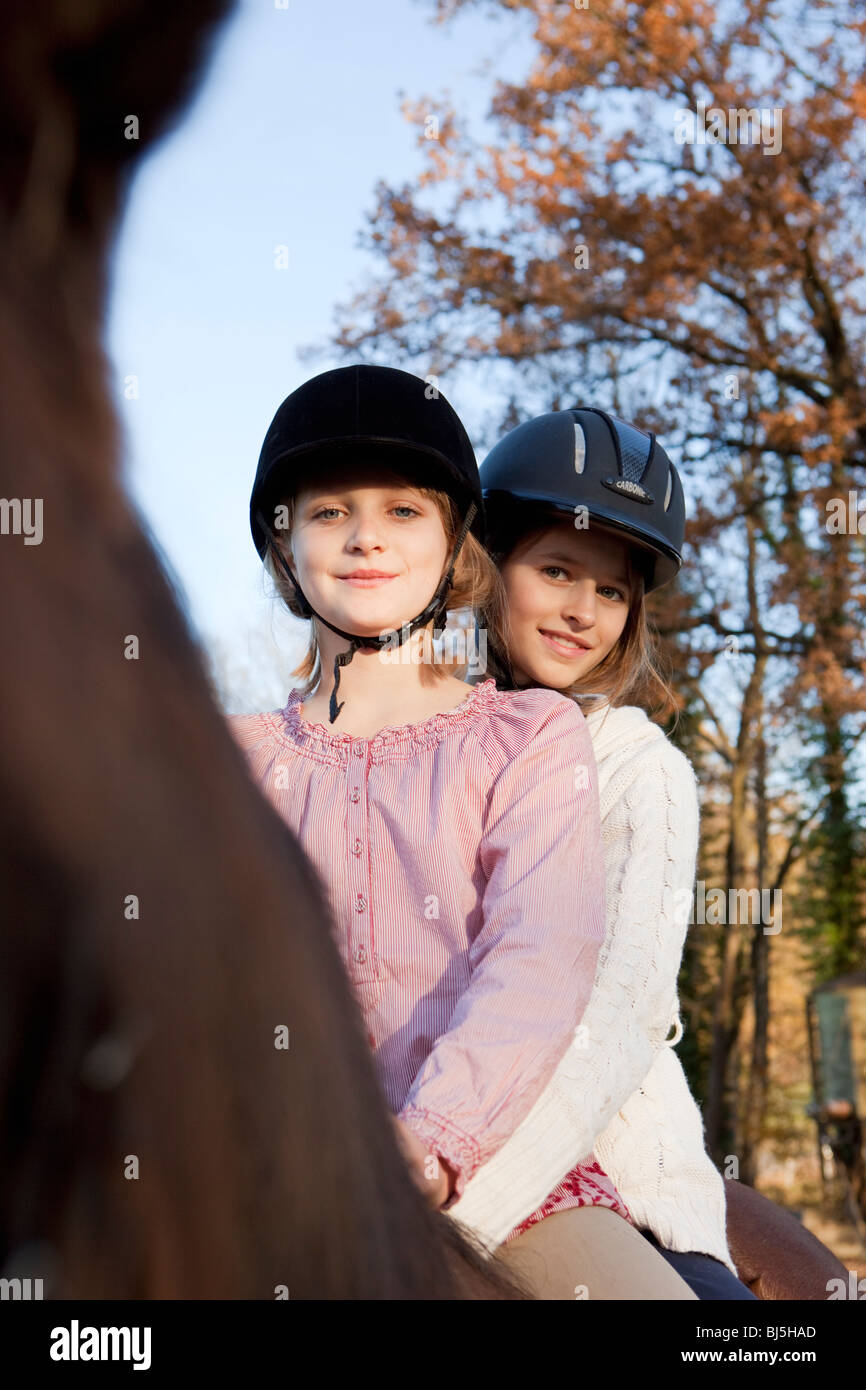 Two girls on a horseback Stock Photo - Alamy