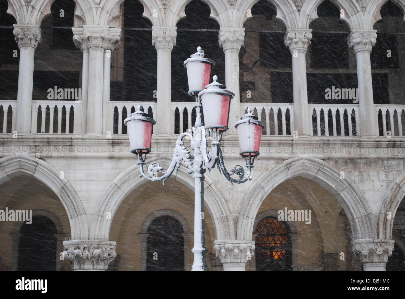 Snowstorm and pink street light in front of the Doge's Palace, St Mark's Square, Venice, Italy Stock Photo