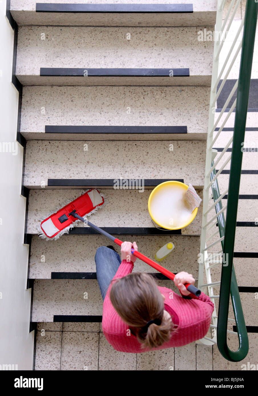 Cleaner cleaning a stairway. Stock Photo