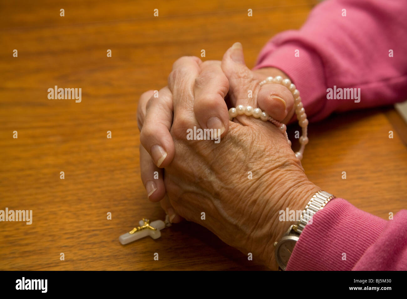 Praying hands holding rosary beads hi-res stock photography and images ...