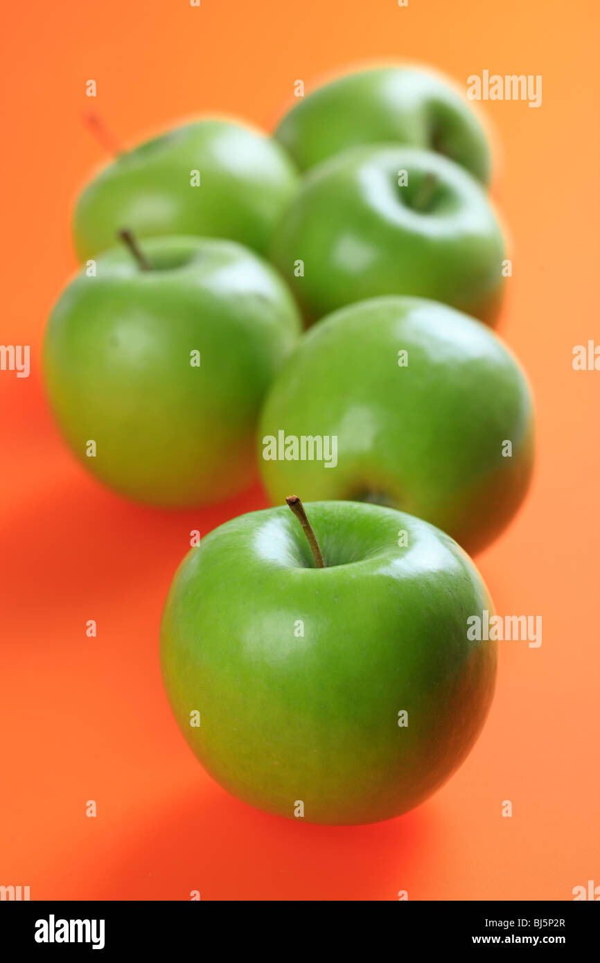 green apples on color background Stock Photo