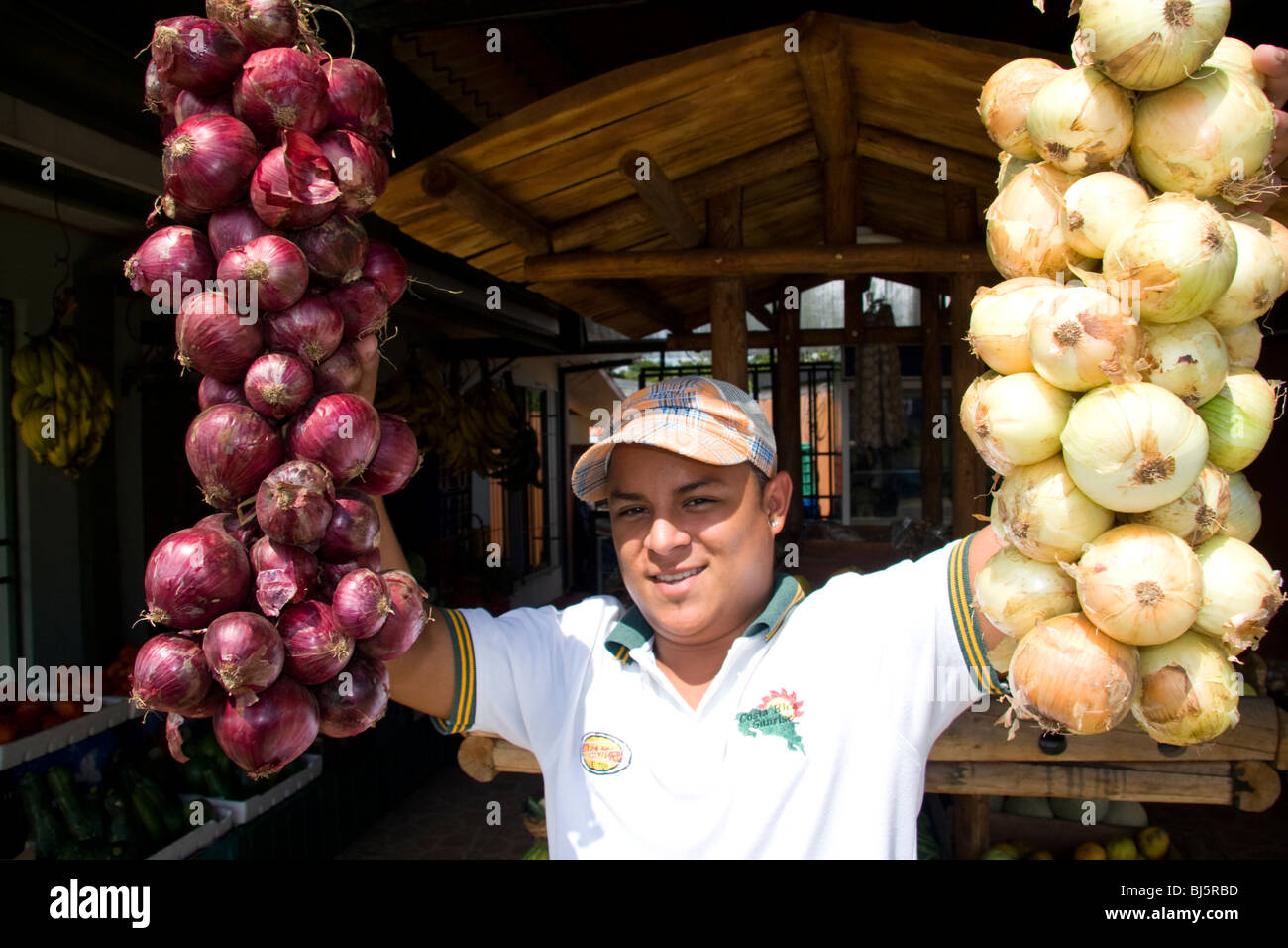Costa Rican man selling onions at La Virgen, Costa Rica. Stock Photo