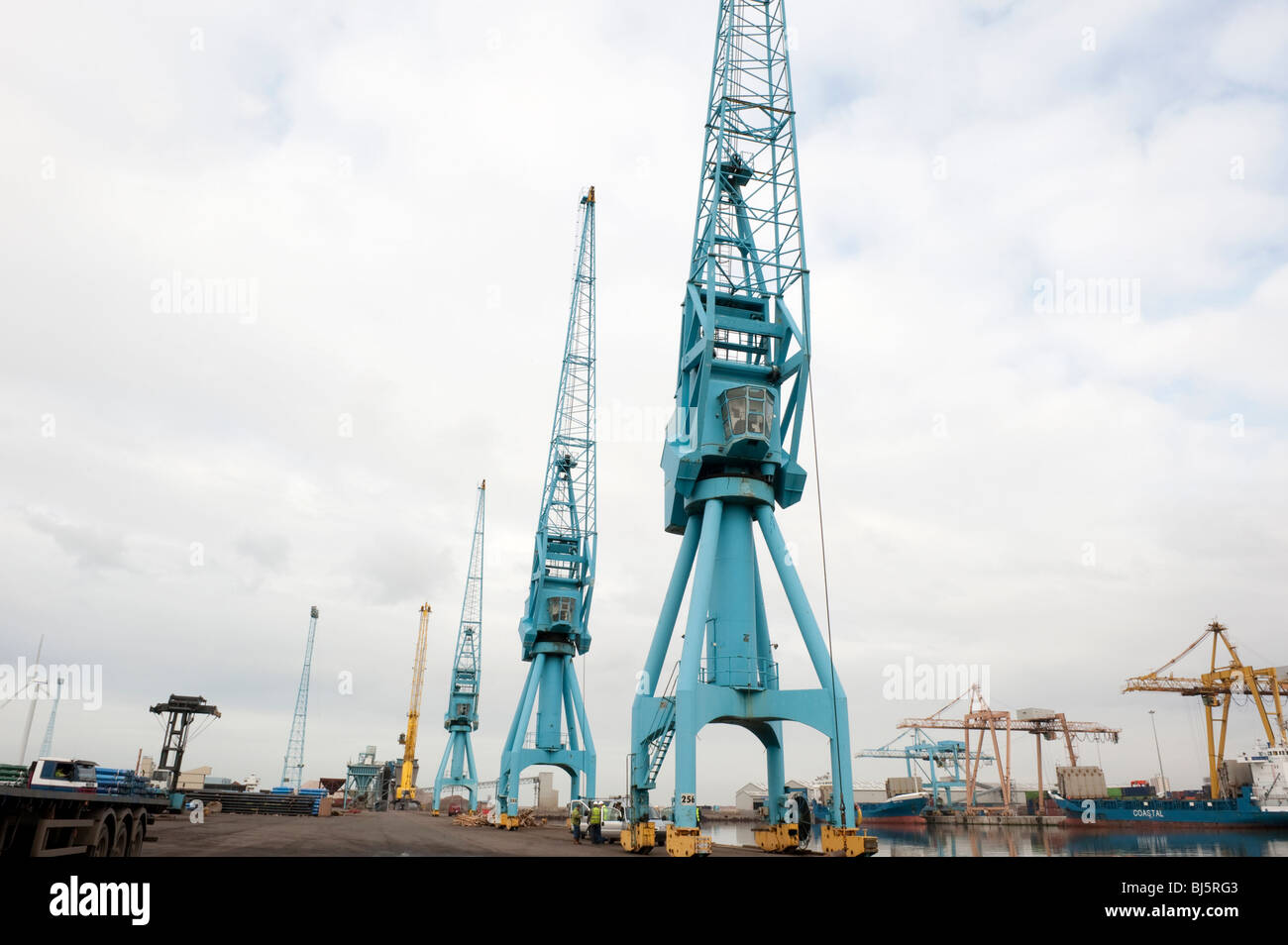 Tall blue dockside cranes for unloading ships Stock Photo