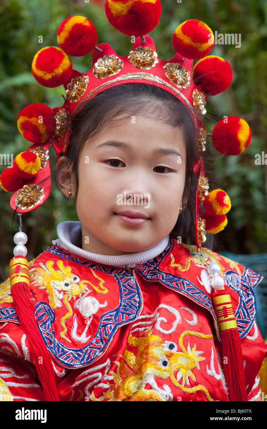 Young girl in traditional costume participates in the Chinese New Year ...