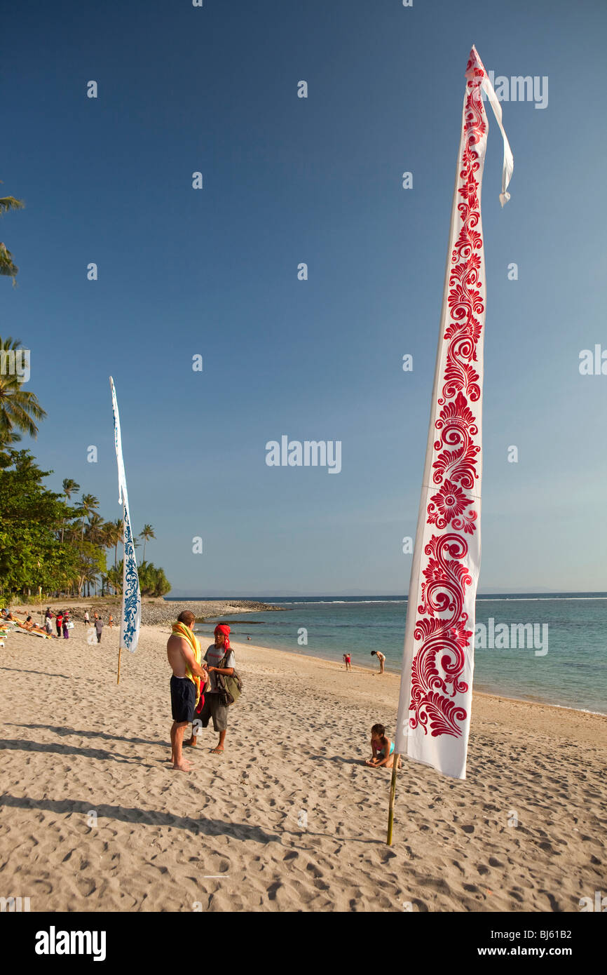 Indonesia, Lombok, Sengiggi, colourful banners on beach at Sengiggi Beach Hotel Stock Photo